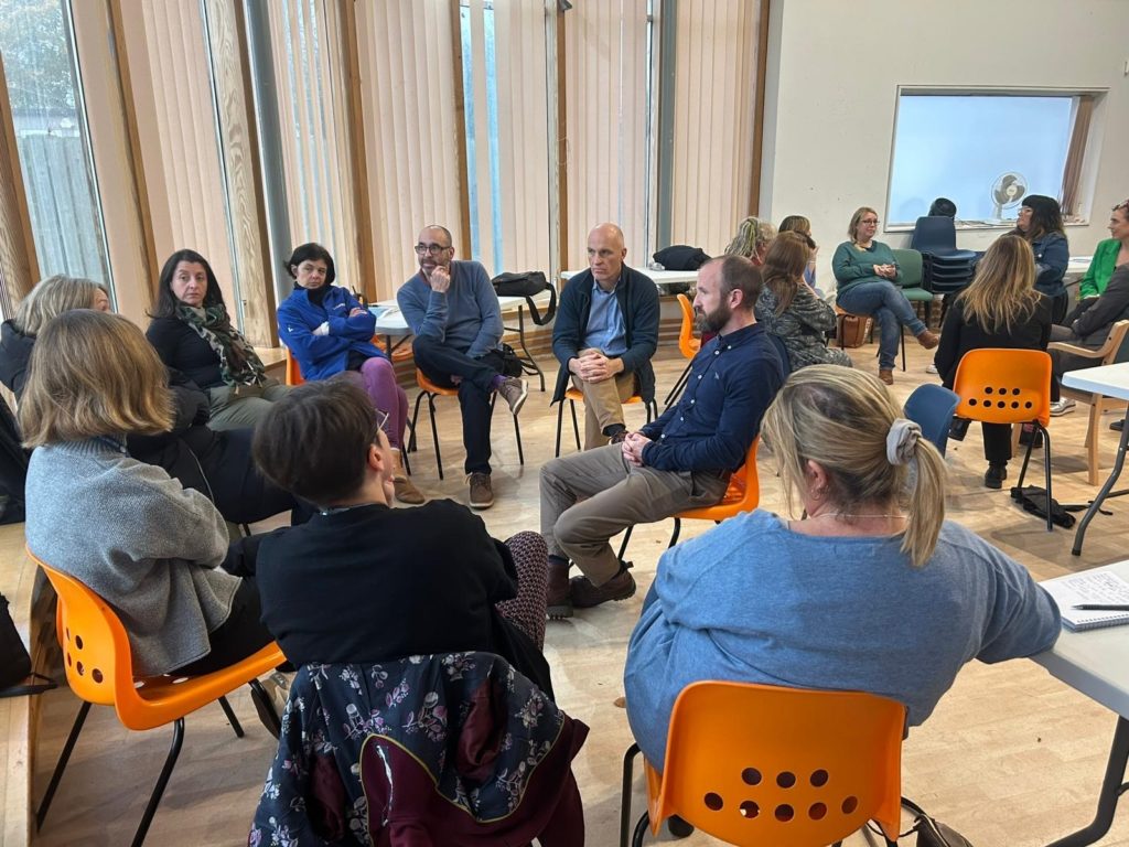 Attendees sitting in circles having discussions at the Bridgwater Neighbourhood meeting